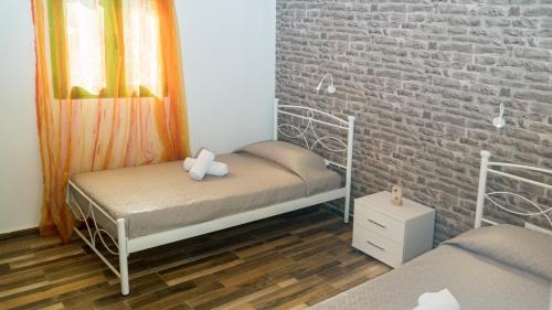 a bedroom with two bunk beds and a brick wall at Villa Elia in Lambiní