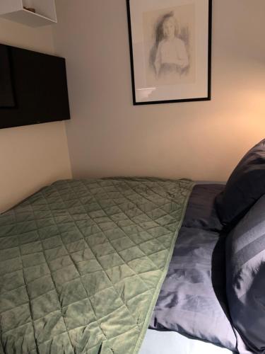 a bed in a bedroom with a picture on the wall at Førde in Førde