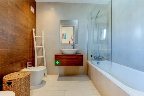 a bathroom with a sink and a toilet and a shower at One Bedroom Apartment in Albur Village 1C in Alvor
