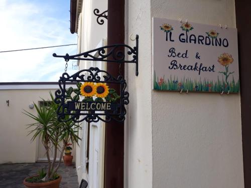 a sign on the side of a building with a sign at B&B Il Giardino in Tavullia