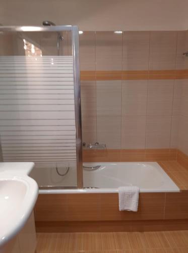 a bathroom with a bath tub and a sink at Astra Villas in Skala Kefalonias