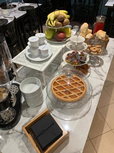 a table with a pie and other food on it at Ristorante Locanda Milano in Gambolò