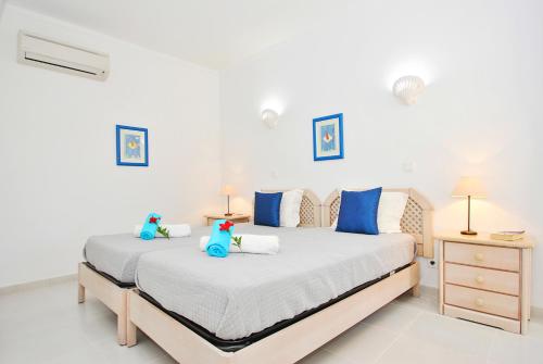 a bedroom with two beds with blue stuffed animals on them at Villa Isa Joe by Algarve Vacation in Almancil