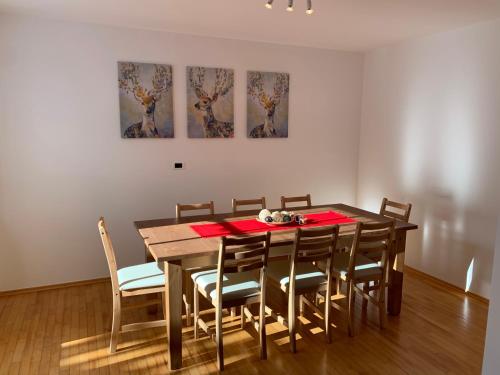 a dining room with a wooden table and chairs at Obereggen - Anna in Eggen