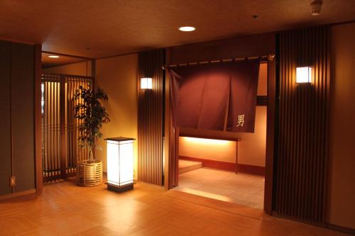a hallway with a curtain and a window in a building at Aki Grand Hotel & Spa in Miyajima