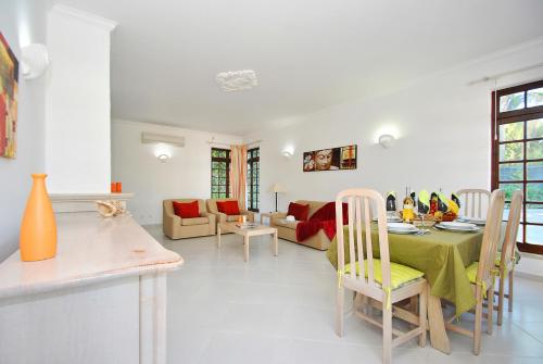 a kitchen and living room with a table and chairs at Villa Isa Joe by Algarve Vacation in Almancil