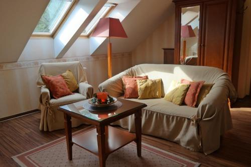 a living room with a couch and a table at Wy & Spa in Pobierowo
