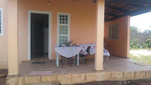 a table and chairs on the porch of a house at Casa Flor De Liz in Alto Paraíso de Goiás