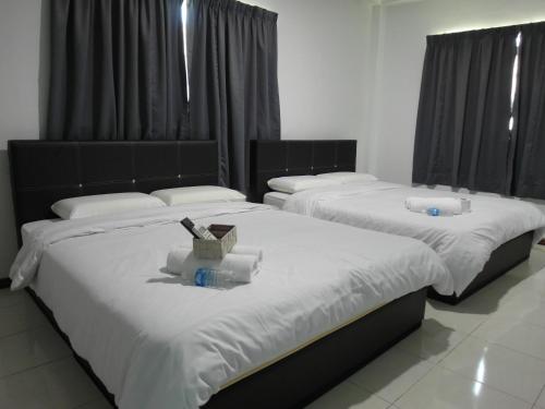 Cama ou camas em um quarto em Klebang Besar Townlodge