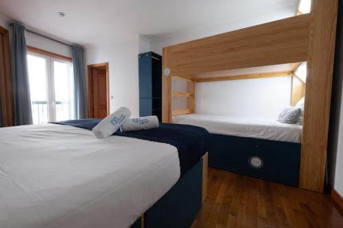 a bedroom with two beds and a window at InnEsposende Sports Hostel in Esposende