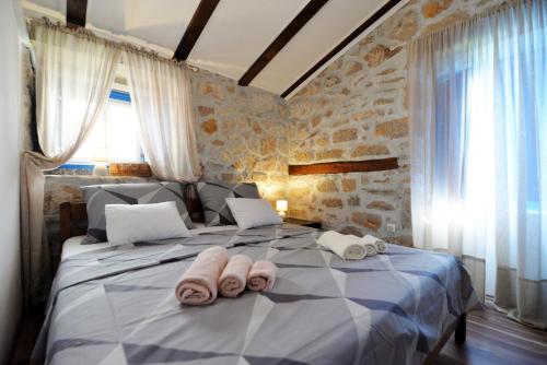 a bedroom with a large bed with towels on it at Melon-1, Murter, House for rest in Murter