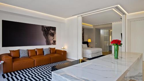 a living room with a couch and a table at PIER 57 - 211 Luxurious & Modern 1 BR Romantic Zone in Puerto Vallarta