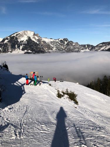 a shadow of a person standing on a snow covered mountain at Apartment Goisernperle in Bad Goisern