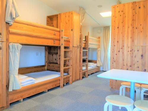 a room with two bunk beds and a table at Kyoto Utano Youth Hostel in Kyoto