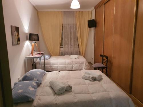 a bedroom with two beds and a desk with a lamp at Casa Mara in Zamora