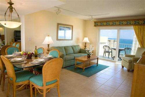 a living room with a couch and a table and chairs at Ft Lauderdale Beach resort in Fort Lauderdale