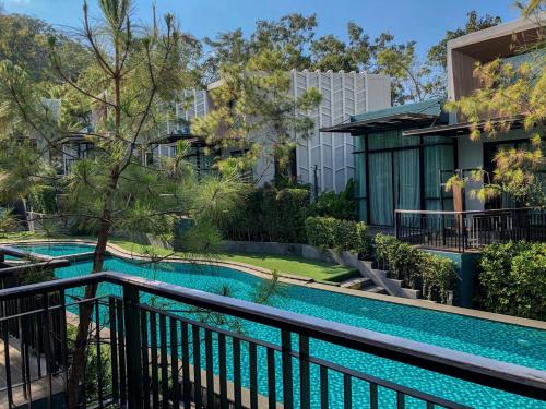 a swimming pool in front of a building at Green Pix Khaoyai in Pak Chong