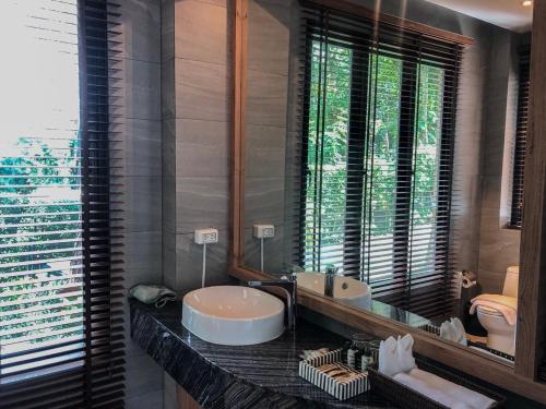 a bathroom with a sink and a mirror at Green Pix Khaoyai in Pak Chong