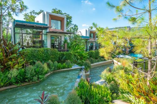 a house with a river in front of it at Green Pix Khaoyai in Pak Chong