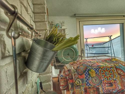 a plant in a bucket hanging on a wall at Chic & Beauty in Agrigento