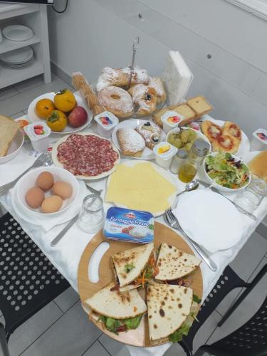 a table with many different types of food on it at Maison De luxe in Pompei