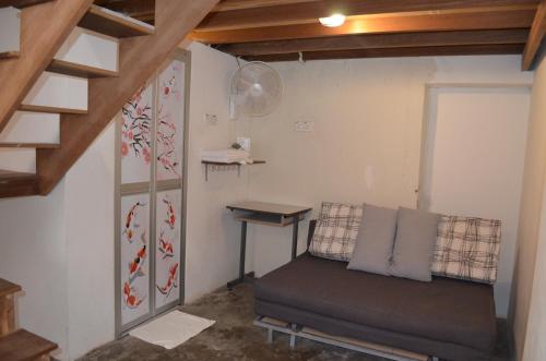 a small room with a bed and a desk at Dou Houz Georgetown in George Town