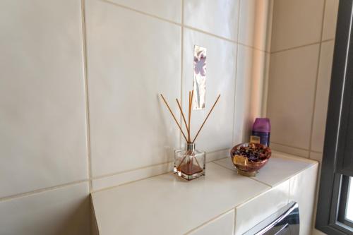 a white shelf with a vase and flowers on it at Margo Zimmer in Midreshet Ben Gurion
