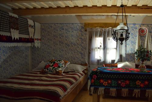 a bedroom with two beds and a window at Casutele Bunicii in Ocna Şugatag