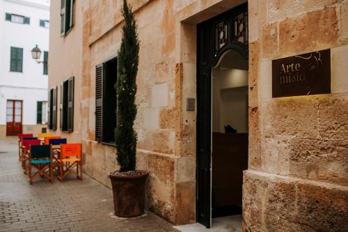 a plant in a pot next to a building at Hotel Artemisia in Ciutadella