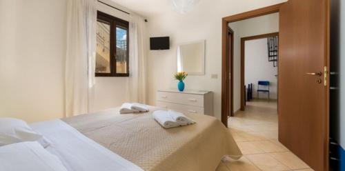 a bedroom with a bed with two pillows on it at Casa Jenny in San Vito lo Capo