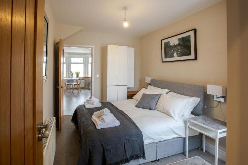 a bedroom with a bed with a stuffed animal on it at Bright and Luxurious Flat in the Heart of Reading in Reading