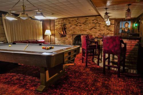 a living room with a pool table and a bar at Unique and Secluded Country Estate near Pittsburgh in Weirton
