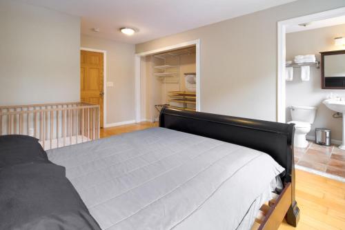 a bedroom with a bed and a walk in closet at The Gray House by Gallaudet 4 BR 3 BA in Washington