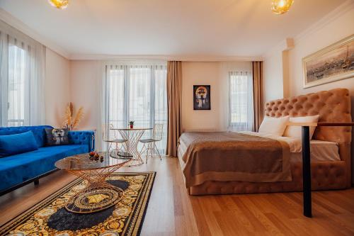 a bedroom with a bed and a blue couch at Taksim Wonder Suites in Istanbul