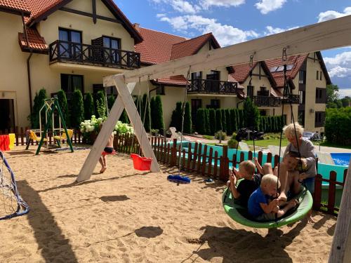 a group of children playing in a playground at Hotel Santa Monica in Mikołajki