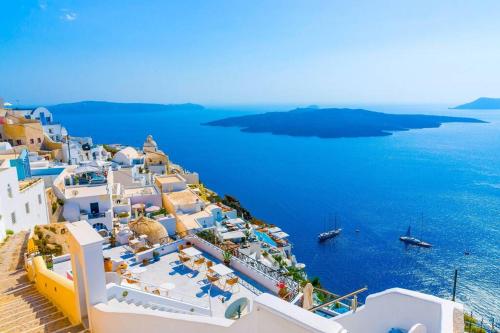 an aerial view of a town with the ocean at Summer House in Santorini in Foinikiá