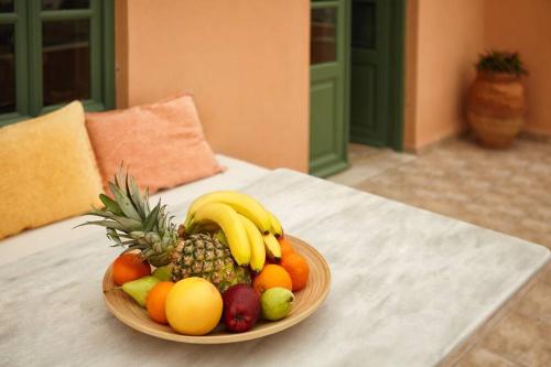 a bowl of fruit on top of a table at Summer House in Santorini in Foinikiá