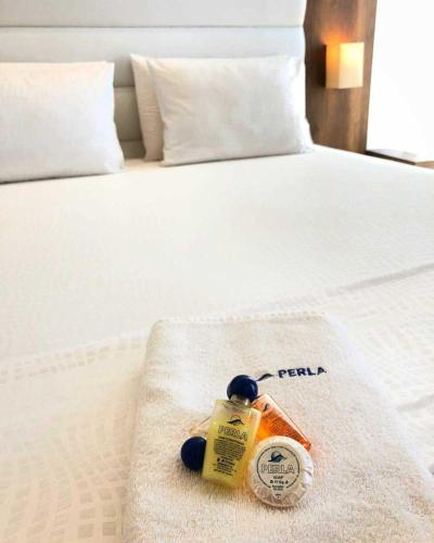 a bottle of fertilizers sitting on a bed at Perla Luxury in Ulcinj