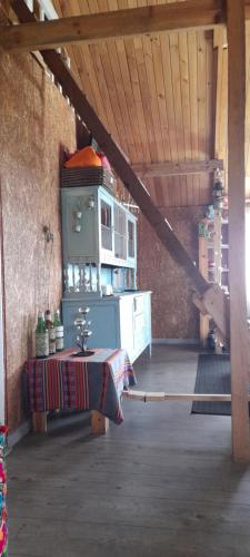 a kitchen with a table and a stove in a room at Espectacular cabaña campestre con granja in Zipaquirá