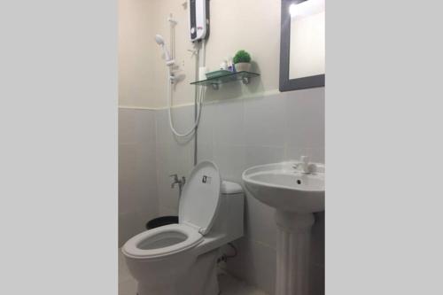 a bathroom with a toilet and a sink at Dencio's Crib in Mactan