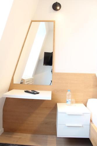 a living room with a mirror and a table at Apartment A605 - Olimpijska kuca Jahorina in Jahorina