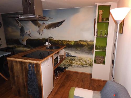 a kitchen with birds on the wall at WadLeuk! in Den Helder