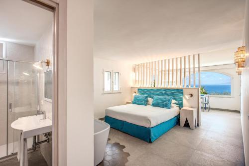 Un dormitorio con una cama, una bañera y un lavabo. en Suitebienvenido, en Massa Lubrense