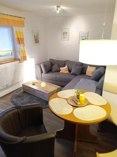 a living room with a couch and a table at CU-Ferienwohnungen - nur für Urlaubsgäste in Grafenwiesen