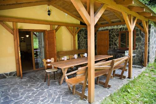 a wooden table and chairs on a patio at Chata Donovaly in Staré Hory