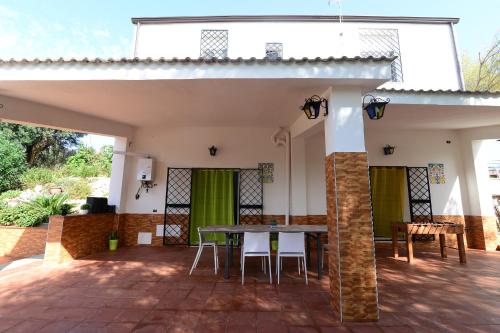 a patio of a house with a table and chairs at Villa Trappeto in Trappeto