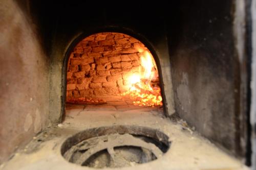 a brick oven with a fire inside of it at Villa Trappeto in Trappeto