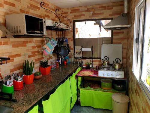 a kitchen with green cabinets and a counter top at Tilcara Hostal Niña Coya in Tilcara
