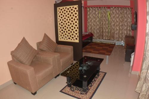 a living room with a couch and a table at The Seaview Residency in Port Blair
