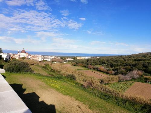a view of a city from a hill with the ocean at La casa di Lo, marina di Sorso in Sorso
